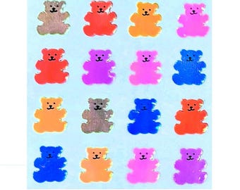 May include: A sheet of colorful bear stickers with a holographic finish. The bears are in various colors including red, orange, yellow, green, blue, purple, and silver.