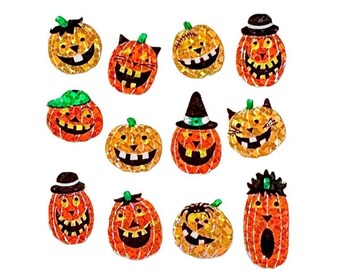 May include: A collection of eleven orange pumpkin-shaped stickers with glittery textures. Each pumpkin features a unique carved face with black eyes and mouths, some wearing hats or accessories like a witch hat, a cap, or a top hat, on a white background.