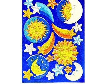 May include: A sheet of stickers featuring celestial motifs on a deep blue background. The designs include yellow suns with faces, crescent moons, shooting stars, and various white, yellow, and blue stars in different sizes and shapes.