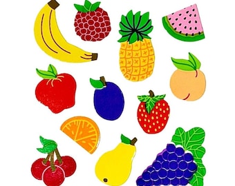 May include: A collection of colorful fruit-shaped wooden cutouts including a yellow banana, red raspberry, yellow pineapple, pink watermelon slice, red apple, purple plum, orange peach, red strawberry, orange slice, red cherries, yellow pear, and purple grapes.