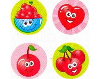 May include: A collection of four circular stickers featuring cartoon fruit and a heart. The stickers include a bowl of red berries, a red heart, a single cherry, and a pair of cherries, each with smiling faces.