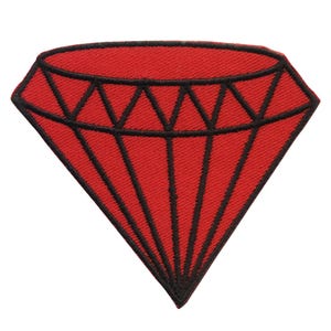 May include: Red diamond shaped patch with black outline. The diamond is filled with red fabric and has a textured look.
