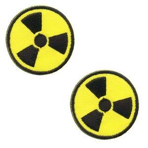 May include: Two yellow and black radiation symbol patches. Each patch is circular with a yellow background and a black radiation symbol in the center. The patches are embroidered.