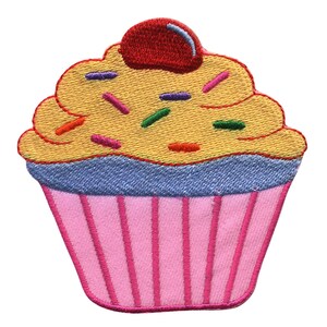 May include: A pink and yellow cupcake with a red cherry on top and colourful sprinkles. The cupcake is embroidered on a fabric patch.