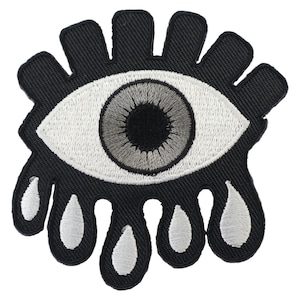 Könnte beinhalten: Schwarz-weiß gestickter Bügel-Patch mit einem weinenden Auge und weißen Tränentropfenformen.