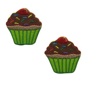 May include: Two embroidered iron-on patches of chocolate cupcakes with green icing and colourful sprinkles. Each patch features a red cherry on top.