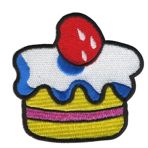 May include: A white and yellow embroidered cupcake with blue frosting and a red cherry on top.