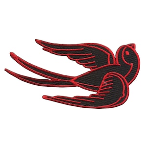 May include: Black swallow bird outline with red stitching. The bird is flying with its wings spread out.