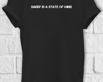 May include: Black t-shirt with white text that reads "Daddy is a state of mind".