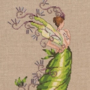 May include: A cross-stitch pattern featuring a green fairy with wings and a flowing gown. The fairy is surrounded by purple and green vines.