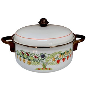 May include: White enamel cooking pot with a lid and two handles. The pot features a fruit tree design with pineapples, cherries, grapes, and strawberries. The lid has a brown knob and a thin orange stripe.
