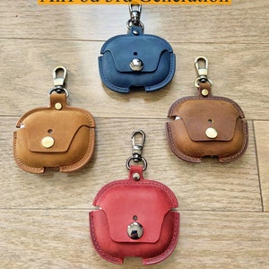 May include: Four leather AirPod 3rd Generation cases with keychains. The cases are in blue, brown, red, and tan. The text "100% Full Grain Leather" is at the bottom of the image.