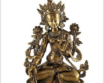 May include: A gold-coloured metal statue of a deity sitting in a meditative pose. The statue is adorned with intricate details and floral accents.