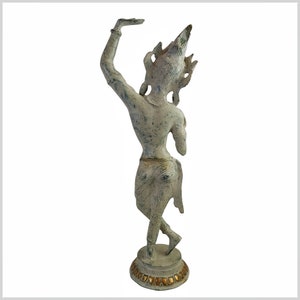 May include: A white and gold painted metal statue of a dancer with a crown on their head. The statue is standing on a round base with gold accents.