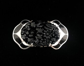 Spilla vintage Art Déco in celluloide: smalto floreale nero, circa 1925.
