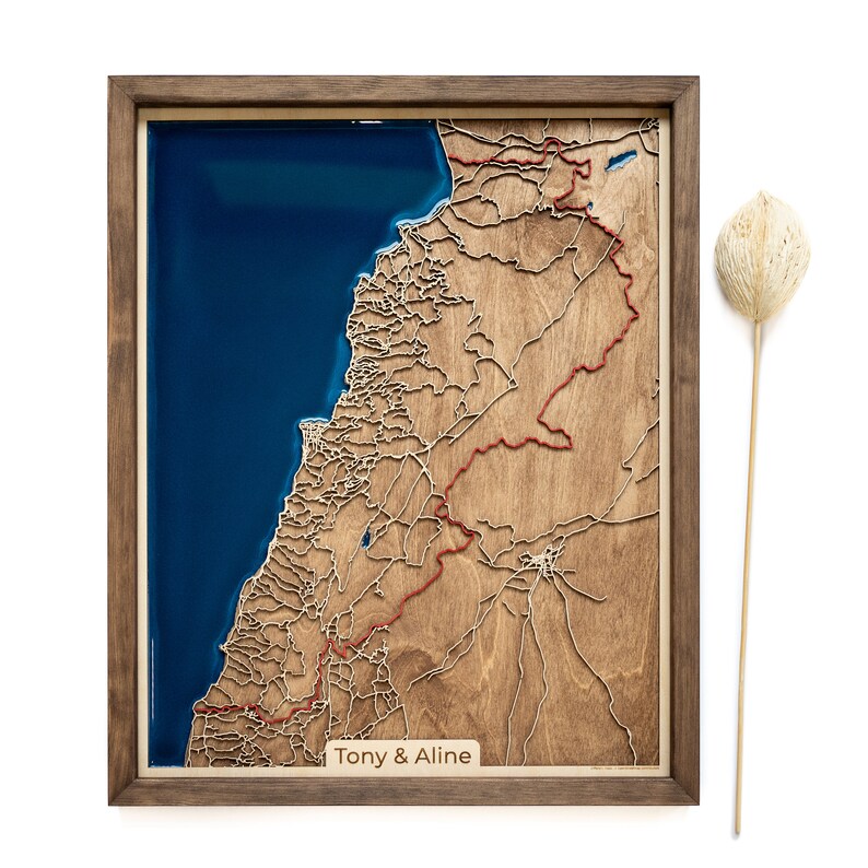 A wooden map of your favourite place enclosed in a wooden frame. It has 3D city streets and epoxy resin water. By adding a pin in a important place for you and an engraving you will make a personalized gift.