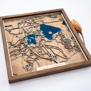 May include: A wooden map with a blue resin lake and the text "I do" - 4/25/17. The map is framed in a dark wood frame.