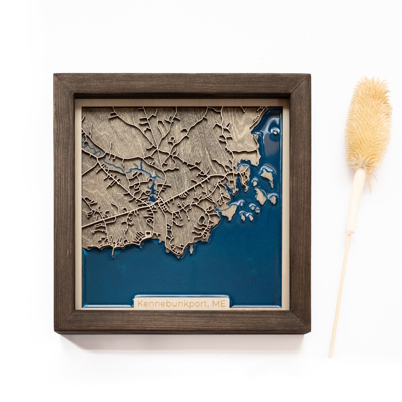 A wooden map of your favourite place enclosed in a wooden frame. It has 3D city streets and epoxy resin water. By adding a pin in a important place for you and an engraving you will make a personalized gift.