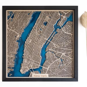 A wooden map of your favourite place enclosed in a wooden frame. It has 3D city streets and epoxy resin water. By adding a pin in a important place for you and an engraving you will make a personalized gift.