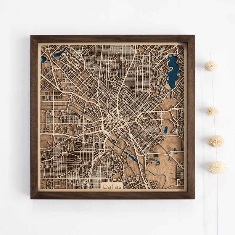 A wooden map of your favourite place enclosed in a wooden frame. It has 3D city streets and epoxy resin water. By adding a pin in a important place for you and an engraving you will make a personalized gift.