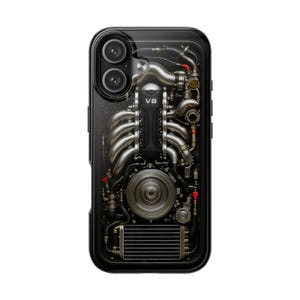 May include: Black phone case featuring a detailed illustration of a V8 engine. The design showcases metallic pipes, gears, and the text "VB". The case has a glossy finish and a dual-camera cutout.