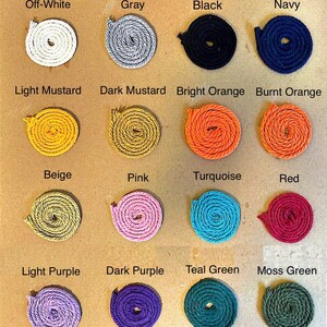 May include: A color chart of 16 different colors of rope. The colors are: off-white, gray, black, navy, light mustard, dark mustard, bright orange, burnt orange, beige, pink, turquoise, red, light purple, dark purple, teal green, and moss green.