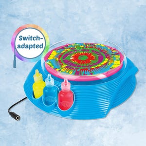 May include: A blue tie-dye art machine with a colorful, circular design. The machine has a pink rim and includes three bottles of paint in yellow, blue, and red. The text "Switch-adapted" is visible.