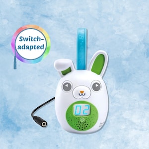 May include: White and green bunny-shaped electronic device with a digital display showing the number 02. The device has a blue handle and a black cord. The text "Switch-adapted" is in a rainbow-colored circle.