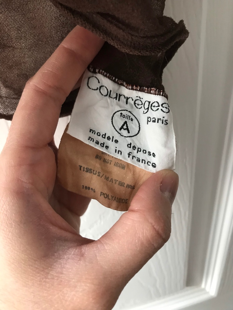 May include: White tag with black text reading "Courr&egrave;ges taille A paris modele depose made in france DO NOT IRON TISSUS/MAT 100% POLYAMIDE"