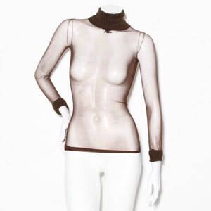 May include: A brown sheer turtleneck top with a knit collar and cuffs. The top is made of a fine mesh fabric and has a fitted silhouette.