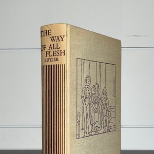 May include: A vintage hardcover book titled "The Way of All Flesh" by Samuel Butler. The book cover is beige with a black and white illustration of a family standing in a room. The spine is brown with vertical stripes.