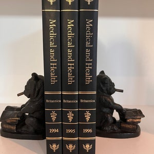 May include: Three black hardcover books titled "Medical and Health" by Britannica. The books are from 1994, 1995, and 1996.