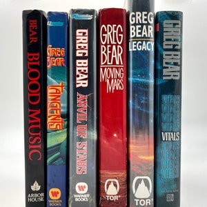 May include: A collection of science fiction paperback books by Greg Bear. The books are arranged from left to right: Bear Blood Music, Tangents, Anvil of Stars, Moving Mars, Greg Bear Legacy, and Vitals. The books are all in different colors and have different covers.