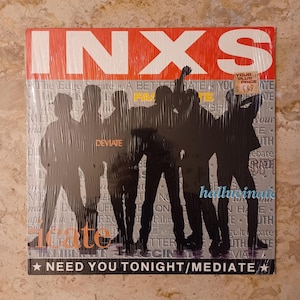 May include: Sealed INXS album cover with the band's name in large white letters on a red background. The album cover features a silhouette of the band members and the text "NEED YOU TONIGHT/MEDIATE".