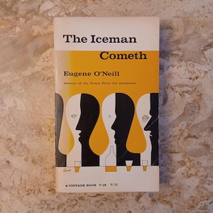 May include: A vintage paperback book titled "The Iceman Cometh" by Eugene O'Neill. The cover features a yellow and black design with stylized human profiles and a bottle. The book is a vintage edition.