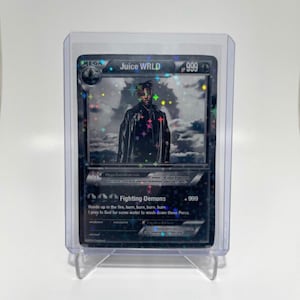 May include: A black and silver Pokemon card featuring a rapper with the text "MEGA Juice WRLD 999" and "Fighting Demons +999" with the text "Hands up in the fire, burn, burn, burn, burn I pray to God for some water to wash down these Percs".