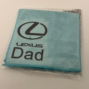 May include: A light blue microfiber cleaning cloth with the Lexus logo and the word "Dad" printed on it.