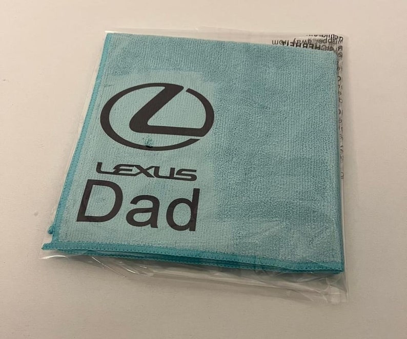 May include: A light blue microfiber cleaning cloth with the Lexus logo and the word "Dad" printed on it.