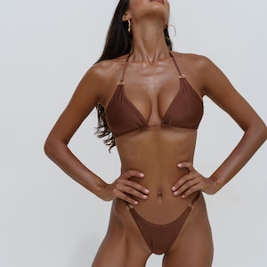 Brown cheeky bikini, bronze triangle top and thong bottom with gold accessories