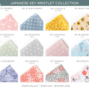 May include: A collection of 12 fabric swatches for key wristlets. The swatches feature various patterns, including bunnies, flowers, bees, and geometric designs. The swatches are labeled with numbers and names, such as "Bunny Pink", "Starflower", "Florals Yellow", and "Busy Bee".