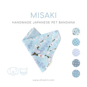 May include: A light blue handmade Japanese pet bandana with a floral pattern. The bandana is folded in a triangle shape, with the text "MISAKI" and "HANDMADE JAPANESE PET BANDANA" in the image. Additional fabric patterns are shown.