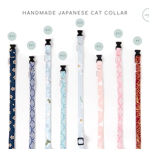 May include: A collection of handmade Japanese cat collars in various patterns and colors. Designs include floral, wave, and cloud motifs. Each collar has a black buckle and is labeled with a number.