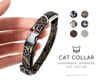 May include: A black and gold cat collar with a Japanese-inspired pattern. The collar has a buckle closure and is adjustable. The collar is handmade and features a variety of patterns, including clouds, waves, and flowers.