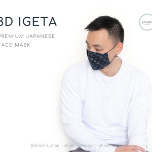 May include: A person wearing a white long-sleeved shirt and a blue and white patterned face mask. The text "3D IGETA PREMIUM JAPANESE FACE MASK" is at the top of the image. The text "@ohashii_shop | ohashiietsy.com | ohashi" is at the bottom of the image.