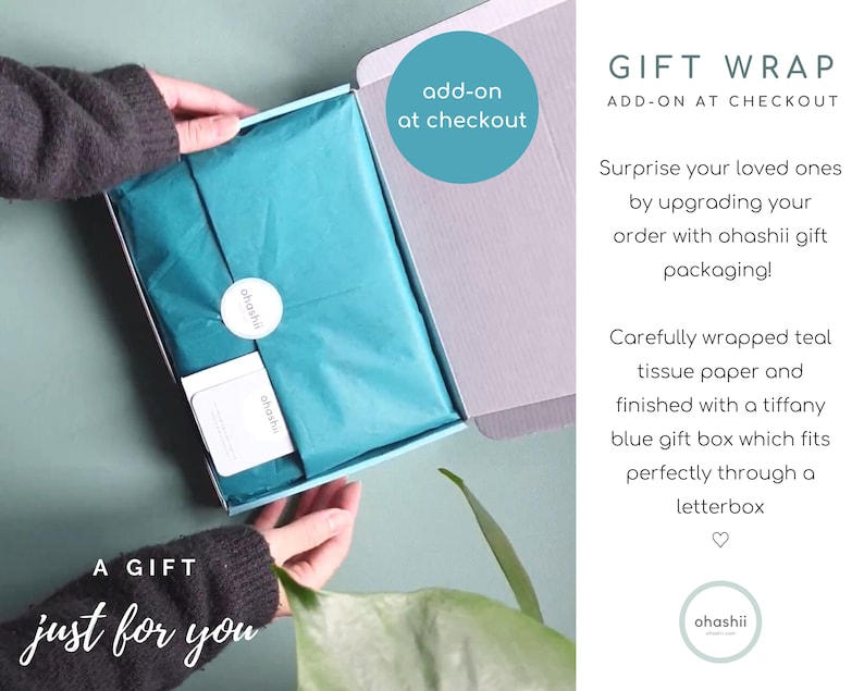May include: A teal tissue paper wrapped gift box with a Tiffany blue lid. The box is labeled "ohashii" and has the text "A GIFT just for you" at the bottom. The text "add-on at checkout" is in a circle at the top of the image. The text "GIFT WRAP ADD-ON AT CHECKOUT" is at the top right of the image. The text "Surprise your loved ones by upgrading your order with ohashii gift packaging! Carefully wrapped teal tissue paper and finished with a tiffany blue gift box which fits perfectly through a letterbox" is below the text "GIFT WRAP ADD-ON AT CHECKOUT".