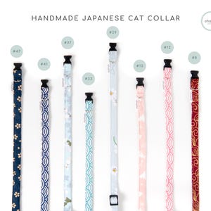 May include: A collection of handmade Japanese cat collars in various patterns and colors. The collars feature floral, wave, and cloud designs in shades of blue, pink, and red. Each collar has a black buckle and is labeled with a number.