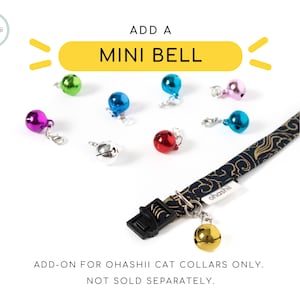 May include: A blue and gold cat collar with a small gold bell charm. The collar has a black buckle and a white label that says "ohashii". The text "ADD A MINI BELL" is written in yellow on a white background. The text "ADD-ON FOR OHASHII CAT COLLARS ONLY. NOT SOLD SEPARATELY." is written in black on a white background.