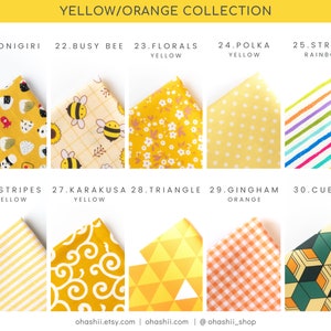 May include: A collection of 10 different yellow and orange fabric swatches with various patterns, including stripes, polka dots, florals, and geometric designs. The swatches are labeled with numbers and names, such as "Onigiri", "Busy Bee", and "Karakusa".