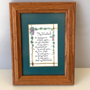 May include: Framed artwork with a wooden frame. The artwork features a handwritten poem titled "My Husband" on a white background, surrounded by green and purple floral accents. The frame has a dark green matting.