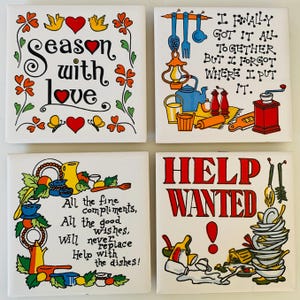 May include: Set of four white ceramic tiles with colorful illustrations and text. The first tile features a heart with the text "Season with love". The second tile features a kitchen scene with the text "I finally got it all together but I forgot where I put it.". The third tile features a kitchen scene with the text "All the fine compliments, all the good wishes, will never replace help with the dishes!". The fourth tile features a pile of dirty dishes with the text "Help Wanted".